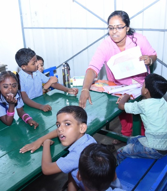 A dedicated teacher guiding special children with care and compassion.