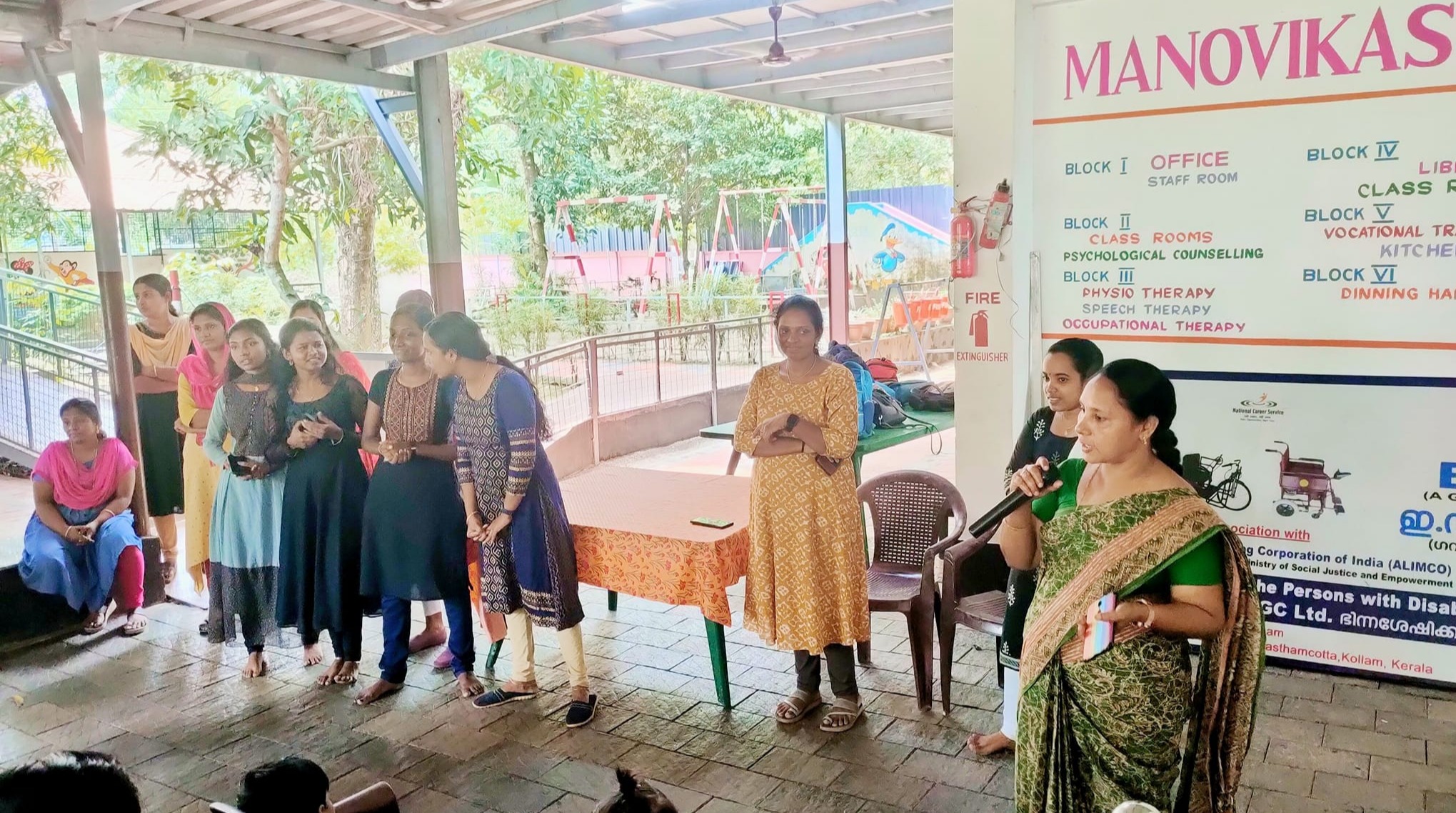 Students from Millath College attentively listening and engaging during their visit to Manovikas Centre